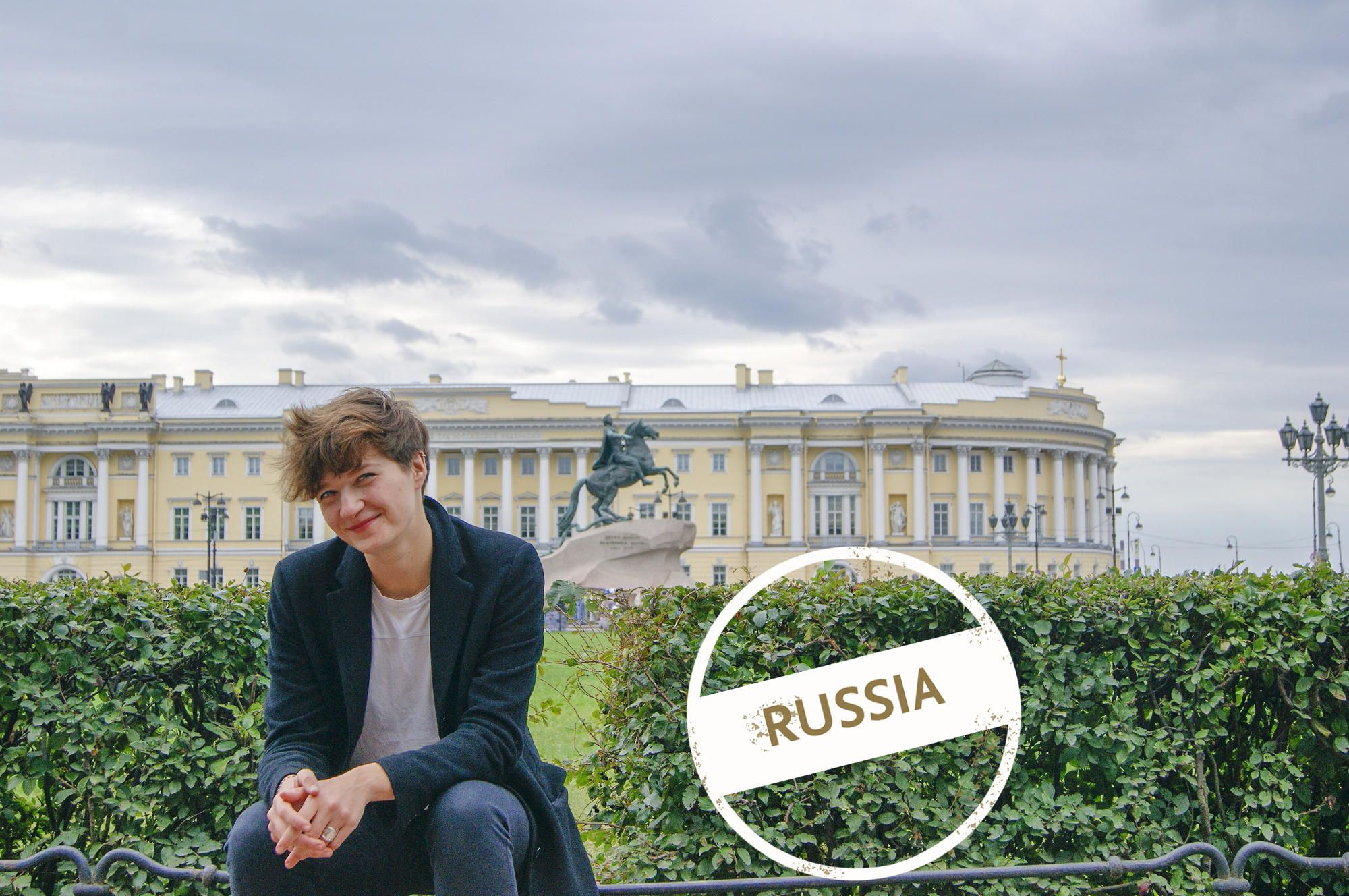 Lilia Becker in front of the Senate Square in Saint Petersburg with the equestrian statue of Tsar Peter the Great in the background.