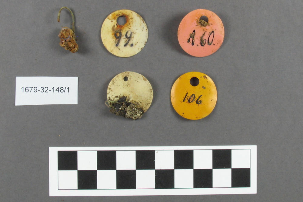 Tags of a synthetic material and metal suspension hooks were among the objects found at the excavation site.