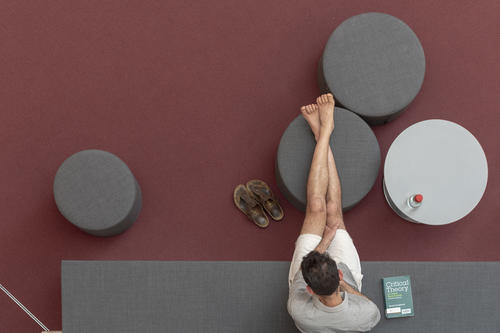 A student sitting in the reading corner of the library on campus